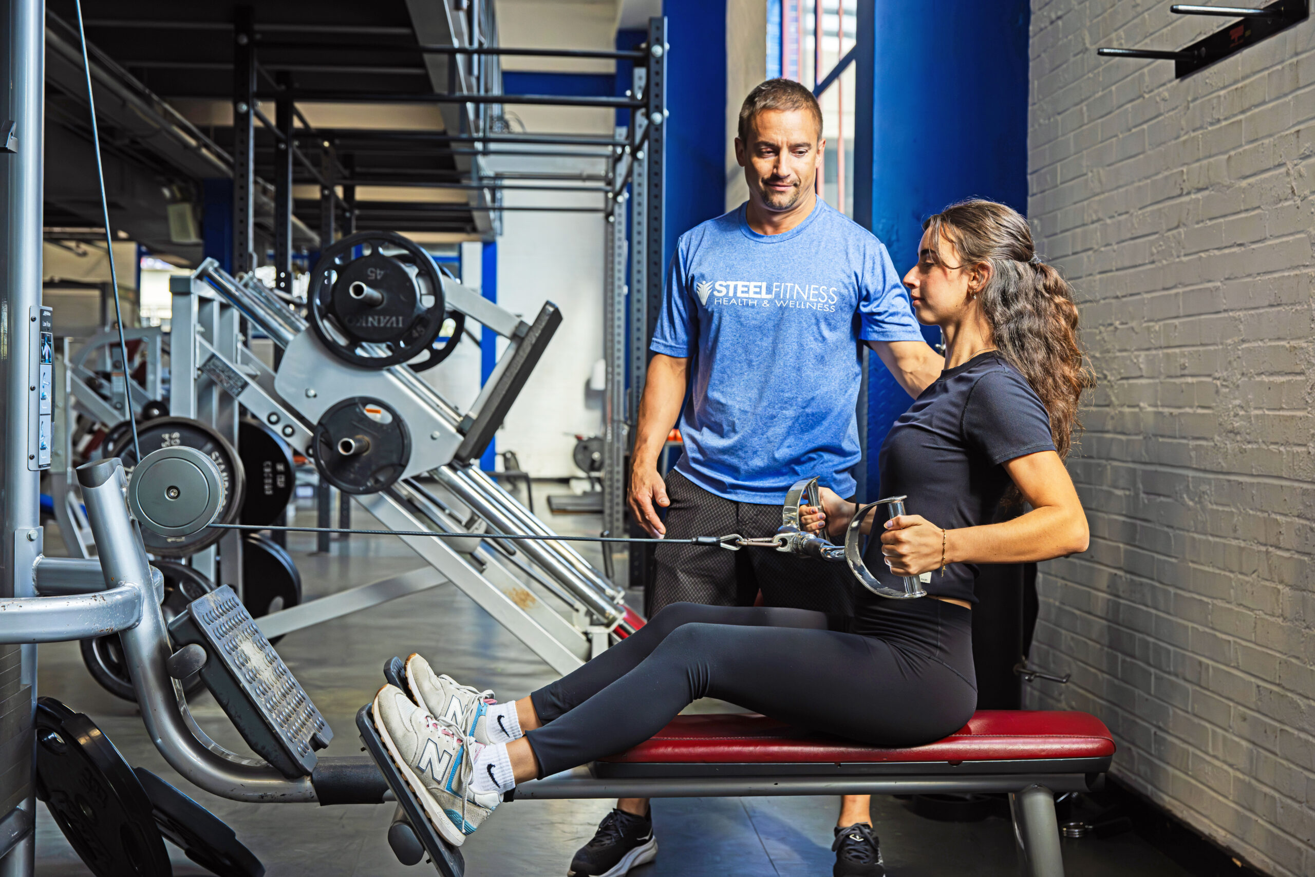 Personal Trainer working with a client on strength machine at Steel Fitness Riverport in Bethlehem