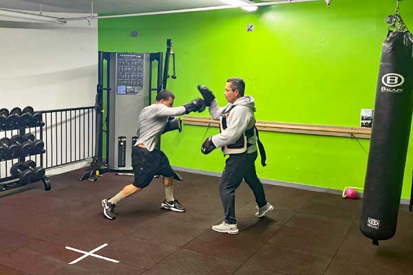 man sparring and boxing with a personal trainer at Steel Fitness Riverport in Bethlehem PA