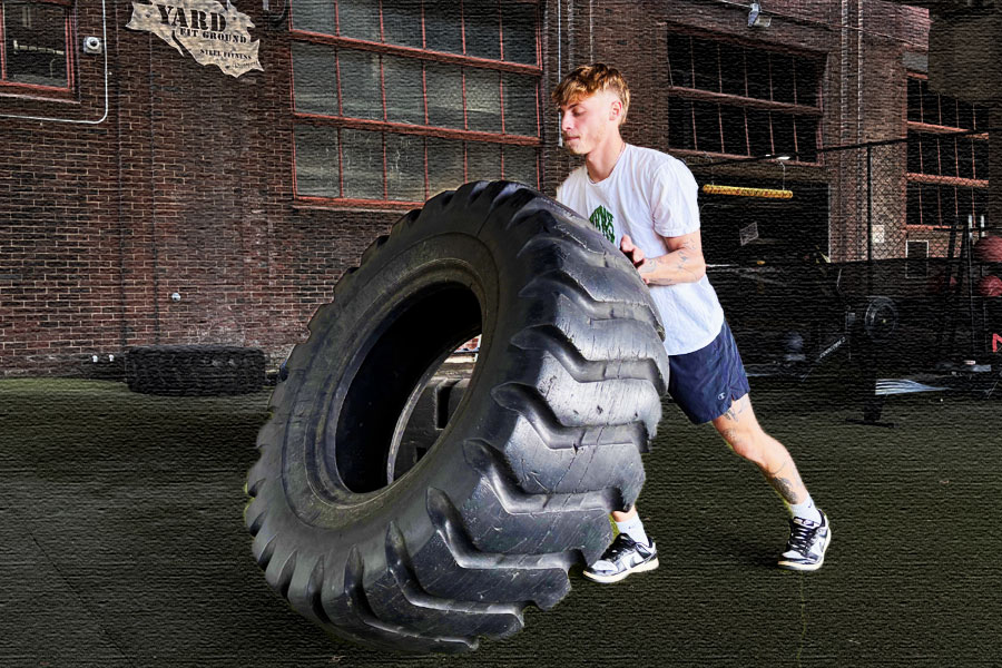 Training with a giant tire at The Yard Outdoor Functional Training Fitground at Steel Fitness Riverport in Bethlehem, PA