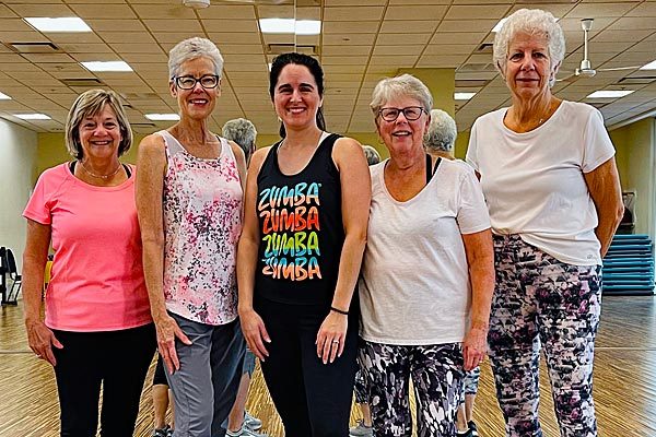 Five women ready to work out and take an exercise class for seniors at Steel Fitness Riverport.